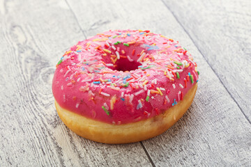 Sweet glazed struwberry donut with icing