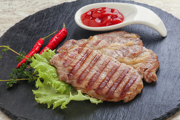 Grilled pork neck steak with ketchup
