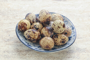 Raw quail eggs heap in the bowl