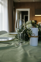 The table is decorated with plates and glasses with flowers on the table
