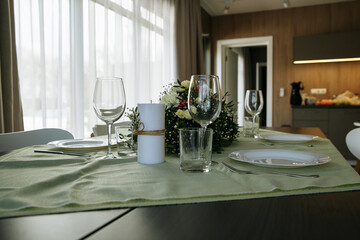 The table is decorated with plates and glasses with flowers on the table