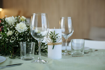 The table is decorated with plates and glasses with flowers on the table