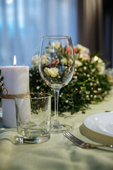 The table is decorated with plates and glasses with flowers on the table