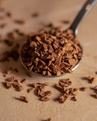 Closeup shot of a spoonful of instant coffee surrounded with granules lying on the table