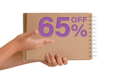 65 percent discount on isolate. Notepad from recycled paper in the hands of a child with text, sale up to 65 percent. The child is holding a notepad demonstrating a big sale.