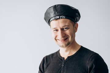 World France day, french guy in black t-shirt and beret stands and looks at camera.