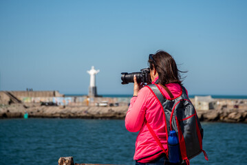 woman taking photos of the port