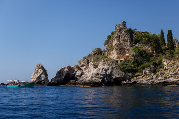 Naklejka premium Taormina, Italy - July 22, 2022: The rocky seaside and coastline below Taormina in Sicily 