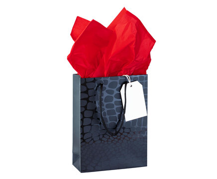 Black gift bag with red tissue paper and white label isolated on white
