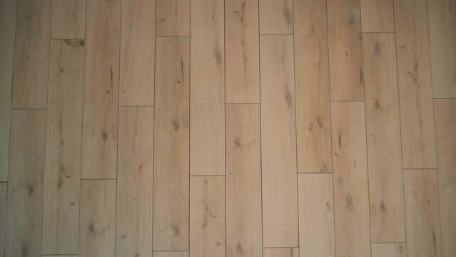 Camera slide on ceramic wood tiles, close-up of floor tiles, walnut ceramic floor