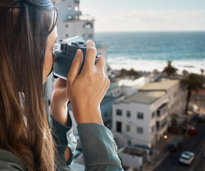 Travel, view and woman with camera at hotel taking pictures of the city, buildings or ocean on...