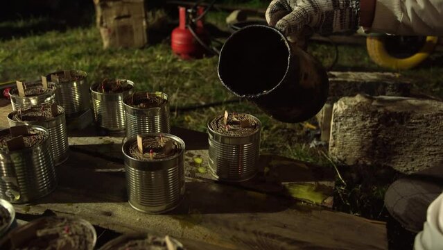 Volunteers helping ukrainian soldiers. Closeup view of team of people making special handmade warming candles for winter season to warm in winter ukrainian troops during war of  Russia against Ukraine
