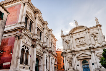 Venice, Italy - July 5, 2022: Building exteriors, boats and gondolas along the canals in Venice Italy
