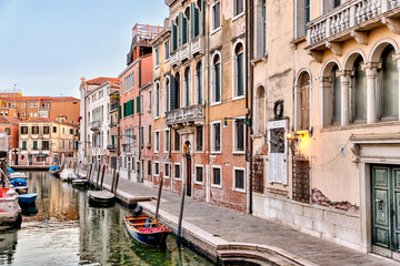 Obraz na płótnie Canvas Venice, Italy - July 5, 2022: Building exteriors along the canals in Venice Italy 