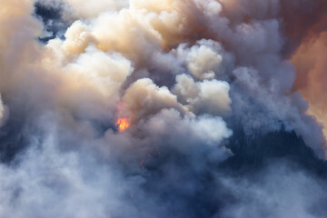 BC Forest Fire and Smoke over the mountain near Hope during a hot sunny summer day. British Columbia, Canada. Wildfire natural disaster