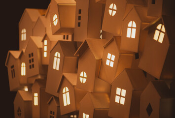 light from the windows of small decorative, white houses on the street of a European city during the winter seasonal holidays