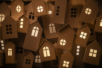 yellow light from the windows of small decorative houses on the city street