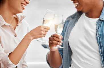 Celebrate, toast and couple with champagne for anniversary, date or luxury travel vacation together. Love, cheers and happy hands of man and woman holding glass of wine for joy, drink and event