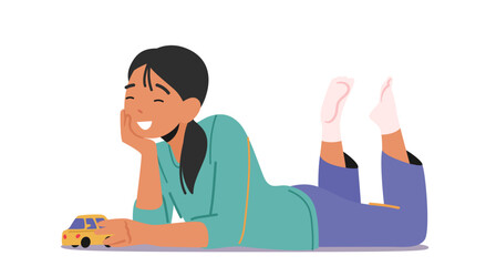 Little Girl with Car Toy in hands, Child Playing Concept. Kid Lying Down on Floor Having Fun and Recreation at Home
