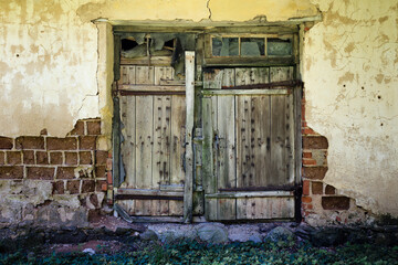 Old abandoned house with a door.