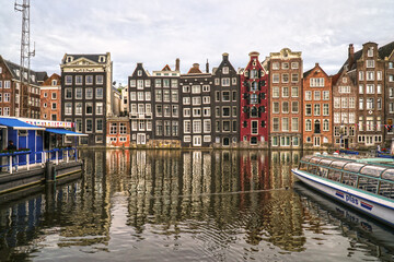  Colourful architecture by the river in Amsterdam. Boats on the river in city of Netherlands.   