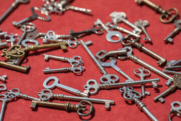 Old vintage keys on red background closeup, concept safety 