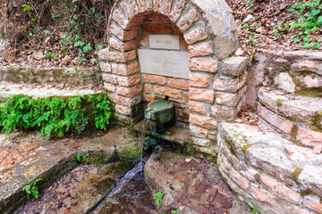 Naklejka premium An old stone faucet with fresh water near Alagonia village in Greece
