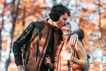 Young couple kissing in the woods. Hiking, outdoors