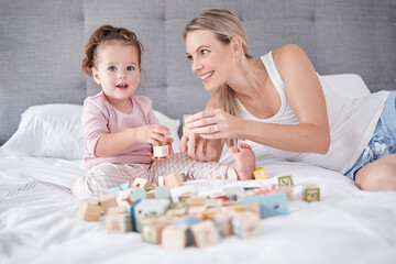 Mom play education game with toys, on bed with child for growth and fun together. Mother smile in...