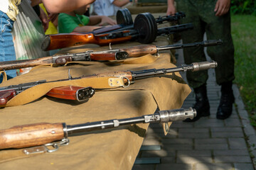 The Kalashnikov assault rifle is on the stand at the firearms exhibition. Measures to increase the...