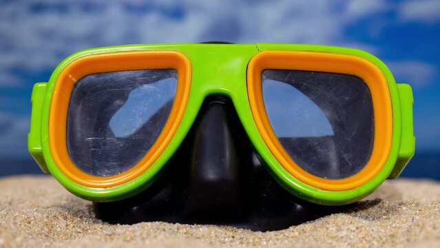 A vintage snorkel mask on the beach