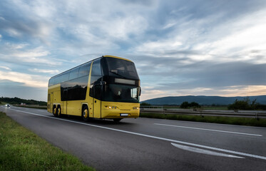 Fototapeta premium Yellow Bus on the country highway road road