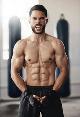 Fototapeta premium Fitness, sport and man boxer with motivation, vision or exercise goals, health and wellness in gym. Powerful flexing of healthy sports personal trainer with workout for muscle training body in studio
