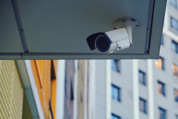 Outdoor surveillance security camera at the entrance of a residential building. CCTV camera on an...