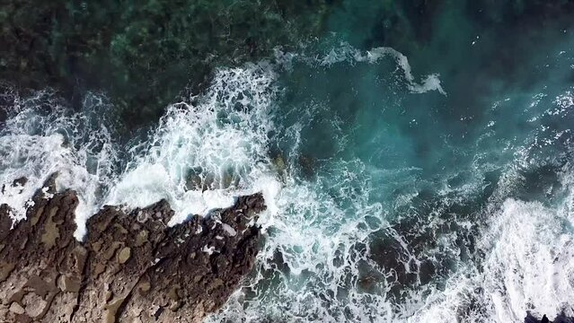 Video from drone of blue sea waves hitting the cliffs