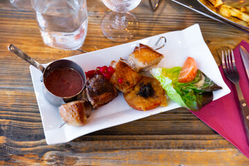 Duck breast on a skewer with red currant sauce. French cuisine
