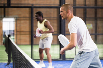 Padel tennis couple in court ready for play and train