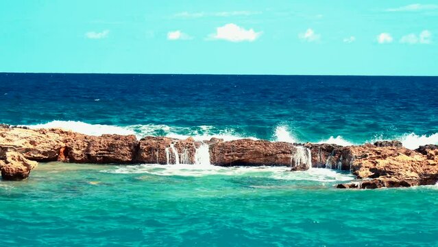 Video of lazur sea waves hitting the big stones