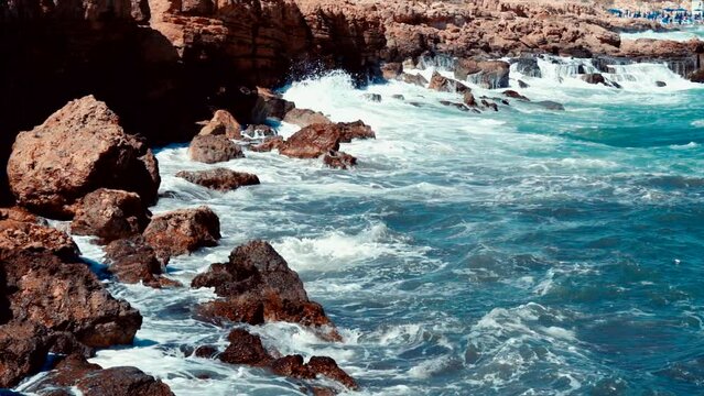 Video of lazur sea waves hitting the big stones