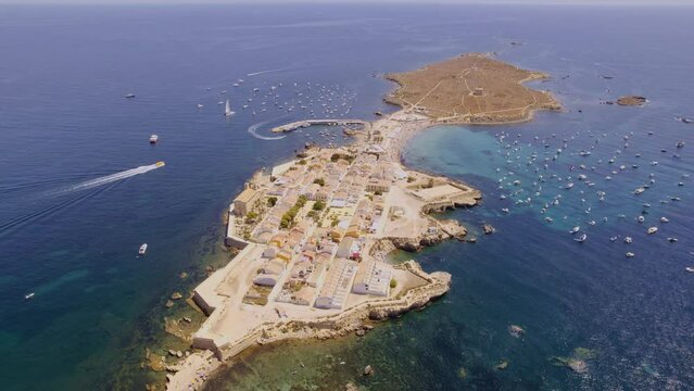 Aerial view of Tabarca island with boats at anchor. Mediterranean Sea. Popular travel destinations at summer. Spain. Cinematic 4K