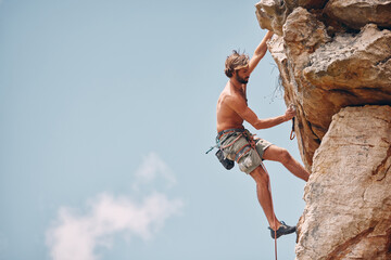 Man mountain or rock climbing while cliff hanging and adrenaline athlete on adventure and check...