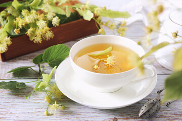 Cup of herbal linden tea with linden flowers