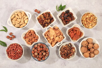 Assortment of various nuts and dried fruits, healthy natural food concept, almonds, nuts, pecans, pistachios, cashews, walnuts and pine nuts, apples, raisins, dried apricots, f