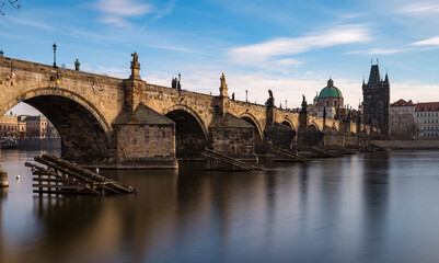 Fototapeta na wymiar Side view of Charles Bridge in Prague on the banks of the Vltava River
