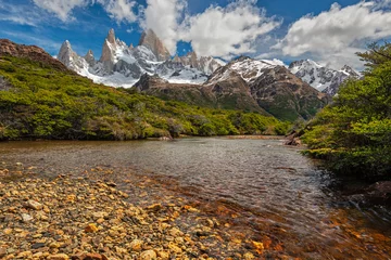 Papier Peint photo Fitz Roy A beautiful river with stones in Los Glaciares national park with the Fitz Roy mountain range in background