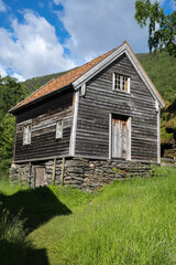 Fototapeta na wymiar Otternes, Norway - June 19, 2022: Otternes, a Norwegian linear and cluster collective farmyard midway between Aurland and Flam. Vestland county. The farmyard consists of 27 buildings. Selective focus