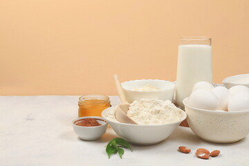 Kitchen background for baking and cooking cake,bread,confectionery and ingredients for cooking,milk,honey,flour,salt,sugar,eggs and cream on pastel background