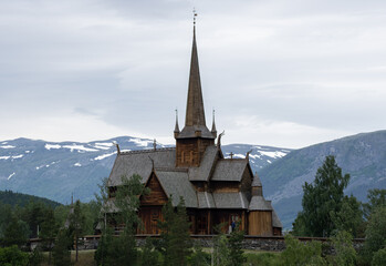 Fototapeta na wymiar Lom, Norway - June 22, 2022: Lom Stave Church is a parish church of the Church of Norway. In Lom municipality. Innlandet. Sunny spring day. Selective focus