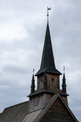Fototapeta na wymiar Kaupanger, Norway - June 23, 2022: Kaupanger Stave Church is the largest stave church in Vestland county. Cloudy summer day. Selective focus