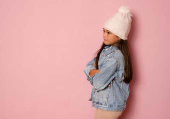 Side view of brunette hispanic girl in winter clothing happy face smiling with crossed arms looking side. Positive person.